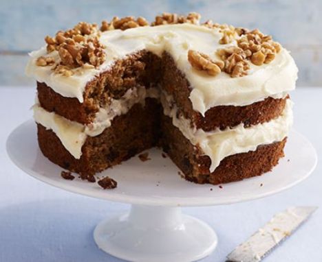 Carrot cake with cream cheese frosting on a cake stand